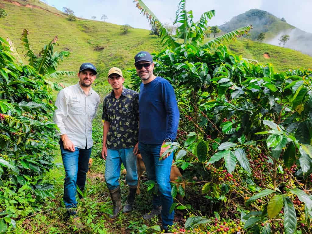 picture showing from left to right: Miguel Echeverri, Hatillo Coffee co-founder, Cristian Perez, El Jardin farm specialty coffee farmer, and Jaime Rodriguez, Hatillo Coffee CEO, standing surrounded of coffee trees near Gomez Plata, Antioquia - Colombia
