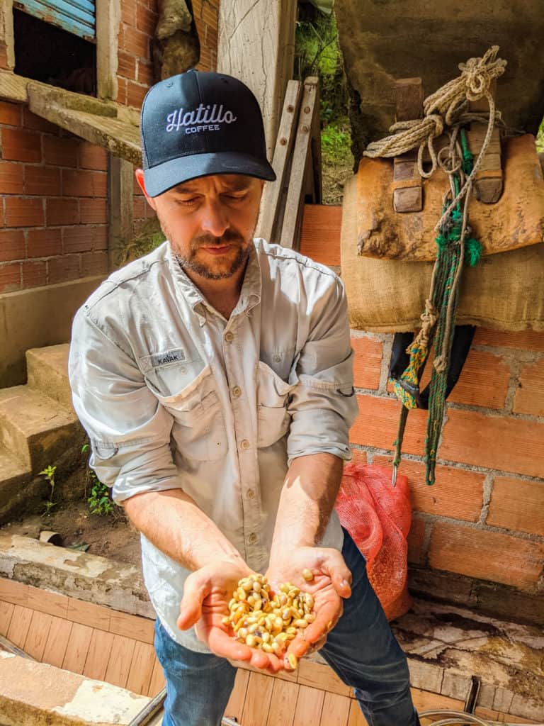 picture showing Miguel Echeverri at Hatillo Coffee El jardin farm showing specialty coffee beans covered with mucilage ready for honey fermentation
