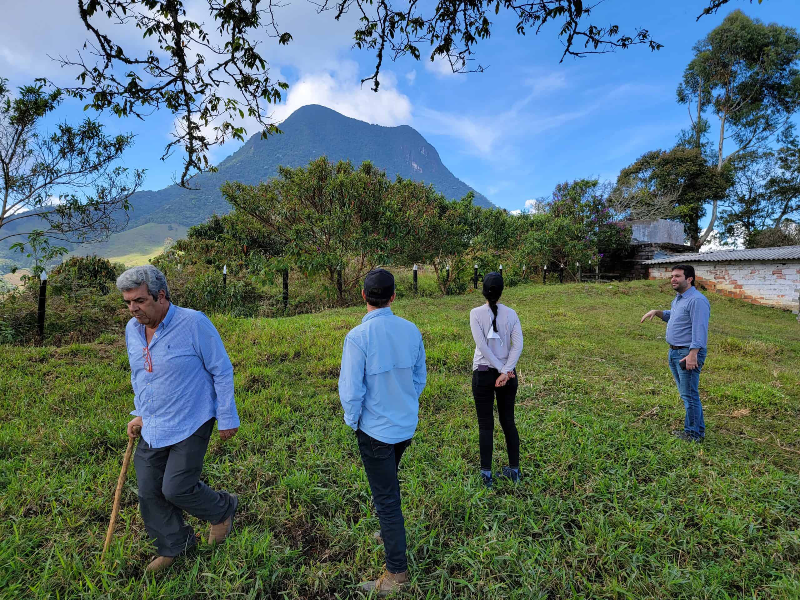 picture showing from left to right, Luis Guillermo Velasquez owner and specialty coffee farmer of "La Melisa" farm, Miguel Echeverri Hatillo Coffee's co-founder and chief quality officer, Marcia Miles CEO of Kiskadee Design, and Felipe Mejia; Luis Guillermo's son-in-law, looking at the majestic "Cerro Bravo" near Fredonia, Antioquia - Colombia from "La Melisa" farm